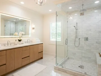Finished master bathroom with large walk-in shower, marble subway tile, and frameless glass enclosure